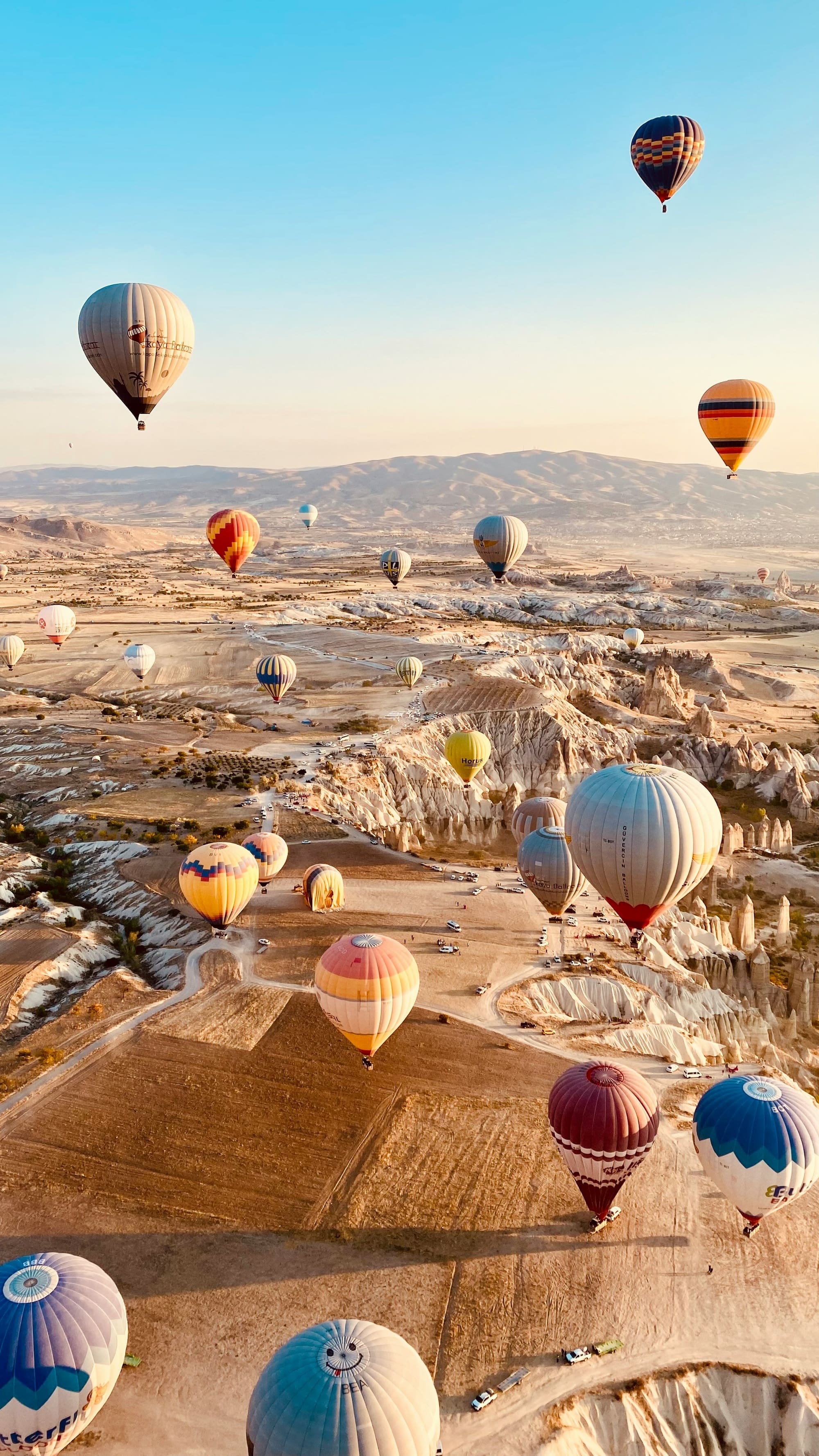 Hot-air balloons drifting over the valleys of Cappadocia at sunrise